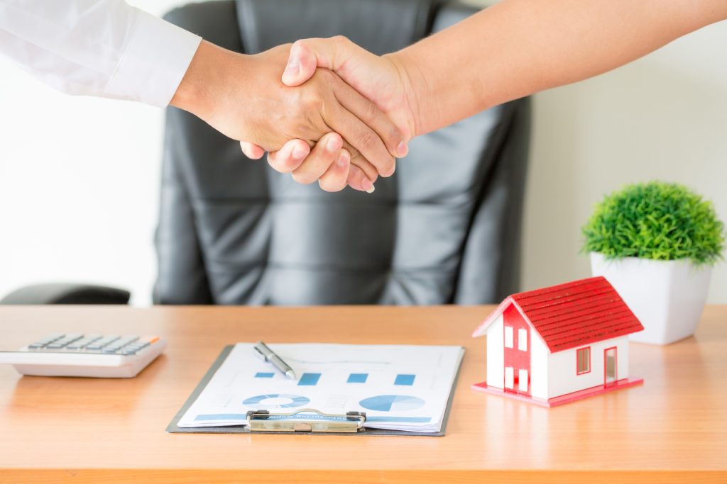 hands agent client shaking hands after signed contract buy new apartment min 1 scaled